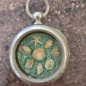 Silver Seashell Pendant with Teal Glitter
